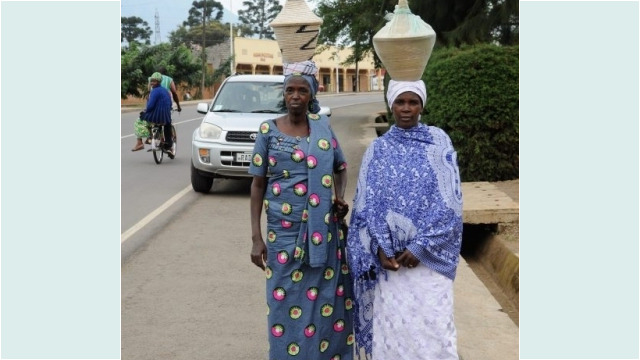 ladies carrying baskets to a wedding, Musanze