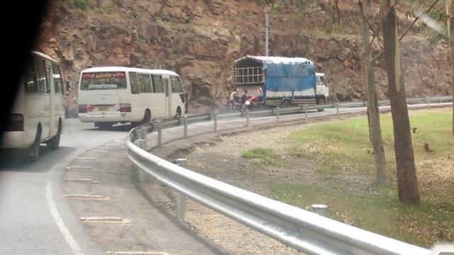 cyclists pulled by truck, north Rwanda